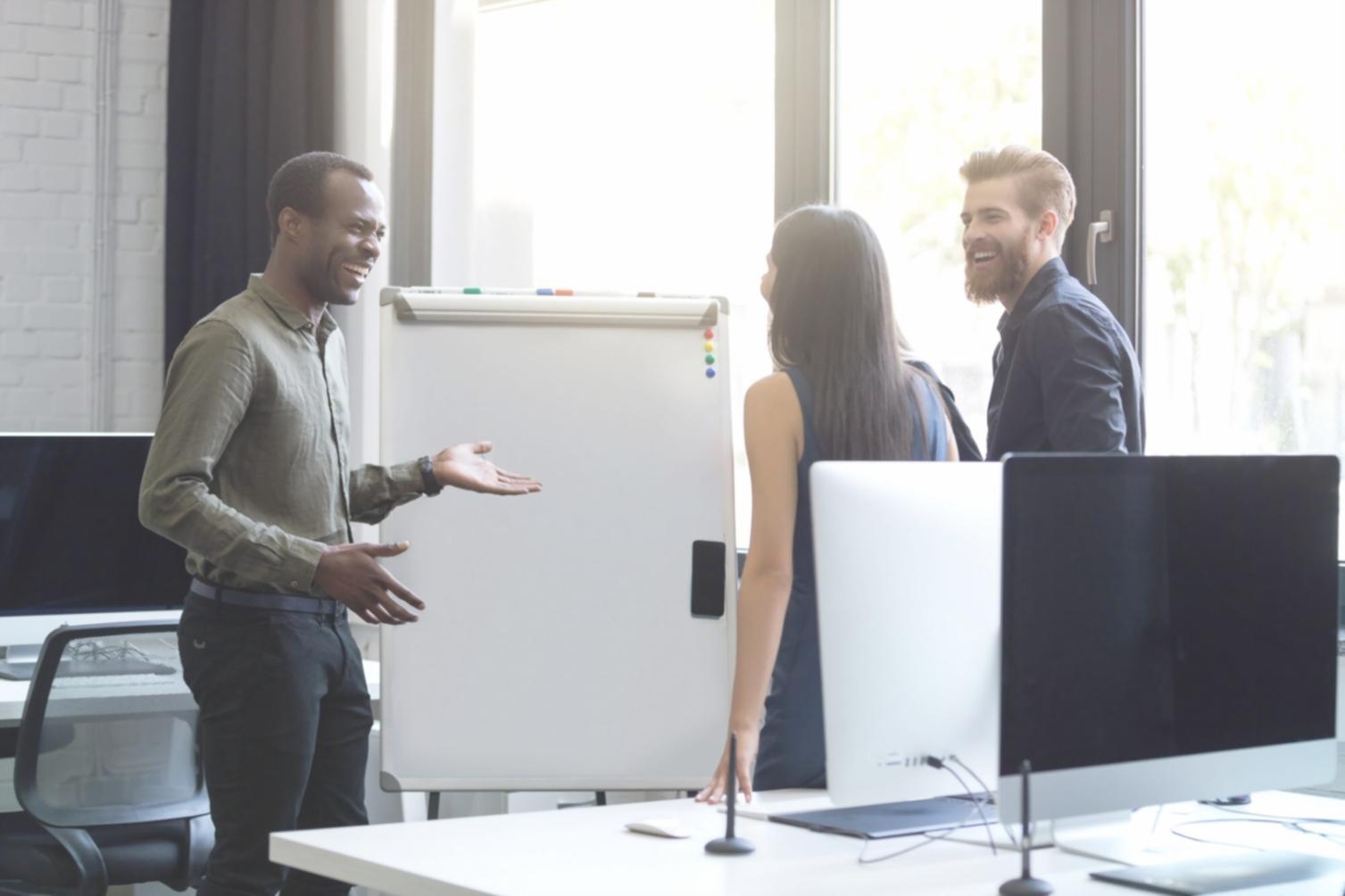 Designer reviewing interface mockups on multiple screens